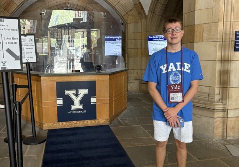 Person standing in Yale University entrance hall.