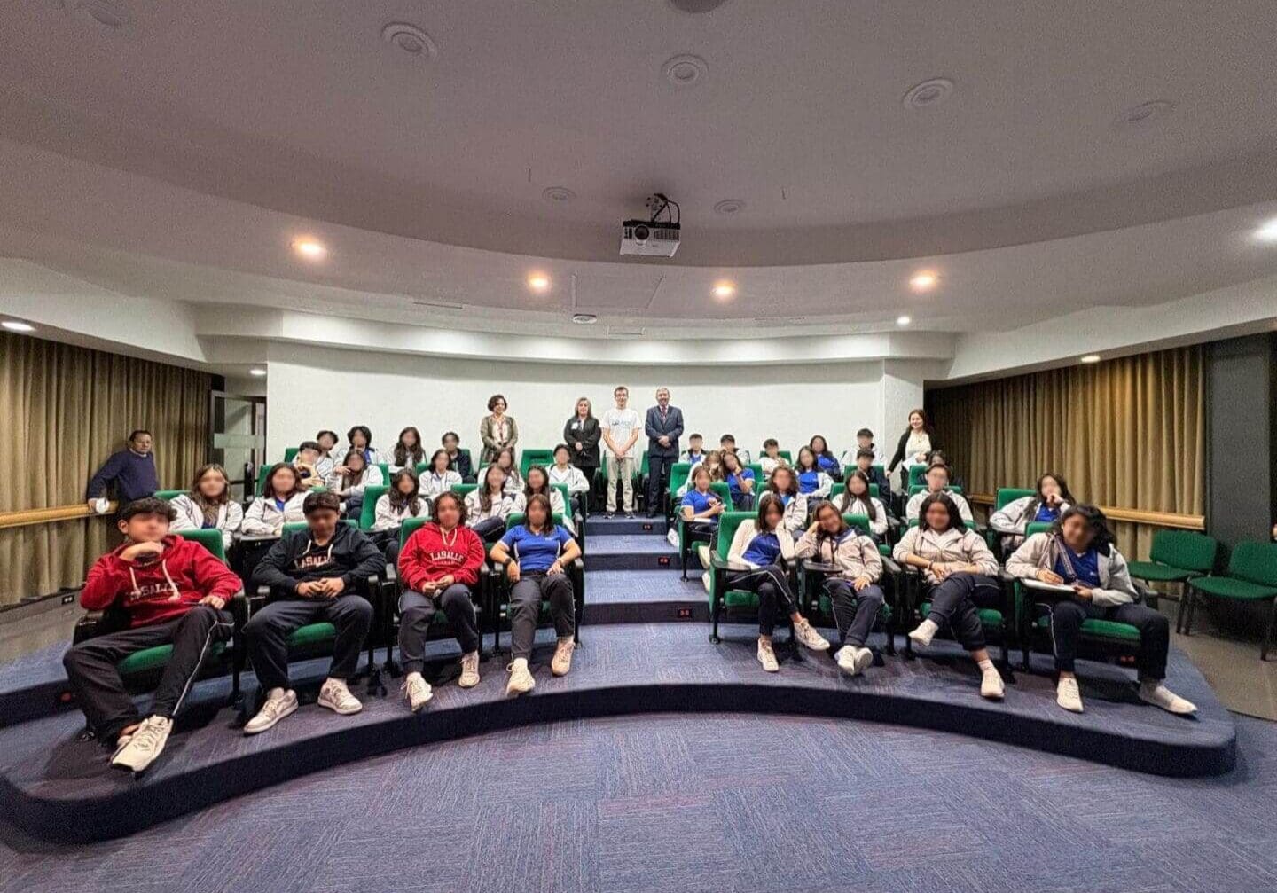 Audience seated in a lecture hall.