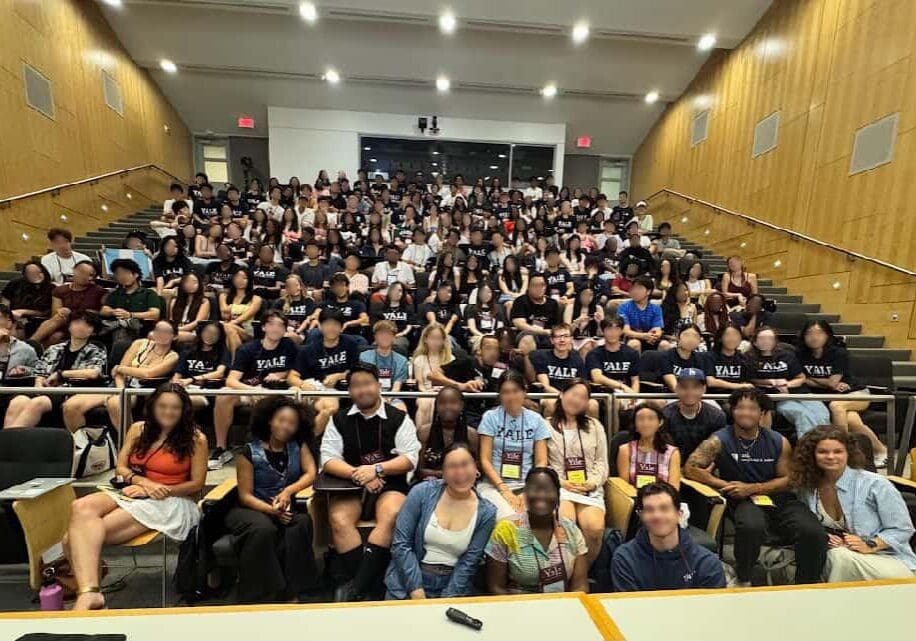 Large group of people in lecture hall.