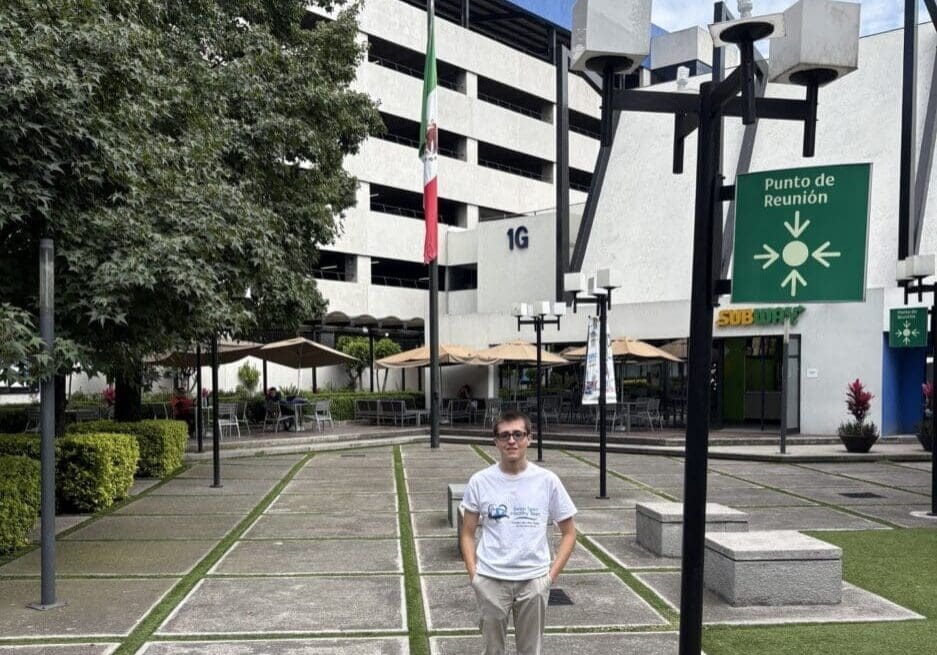 Person standing in front of modern building.